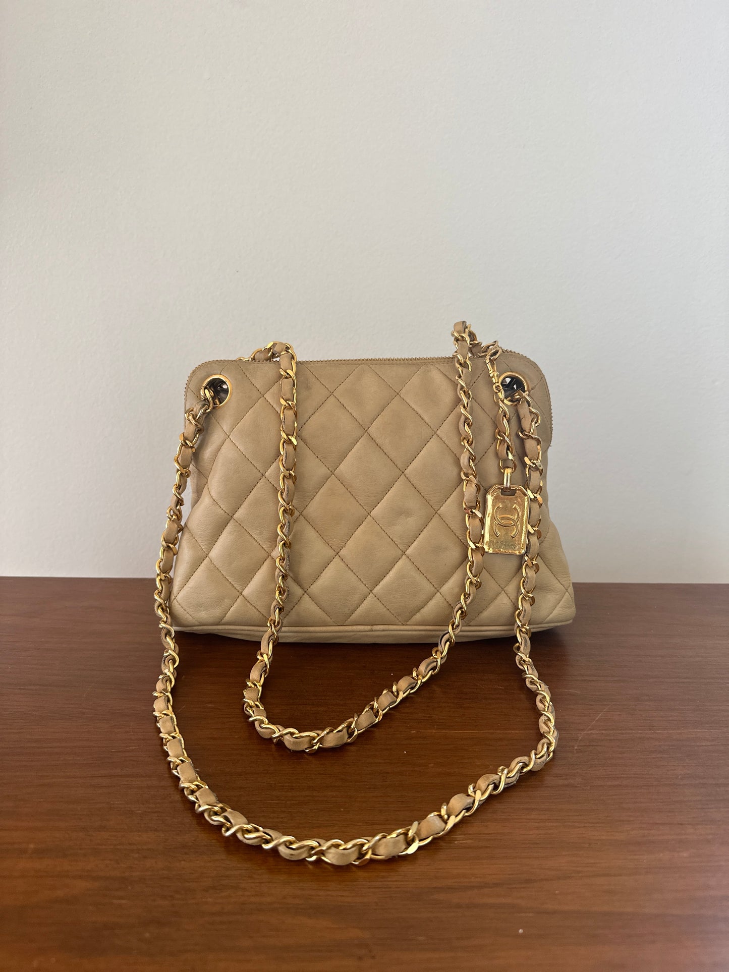 Chanel beige shoulder bag with gold hardware and tag