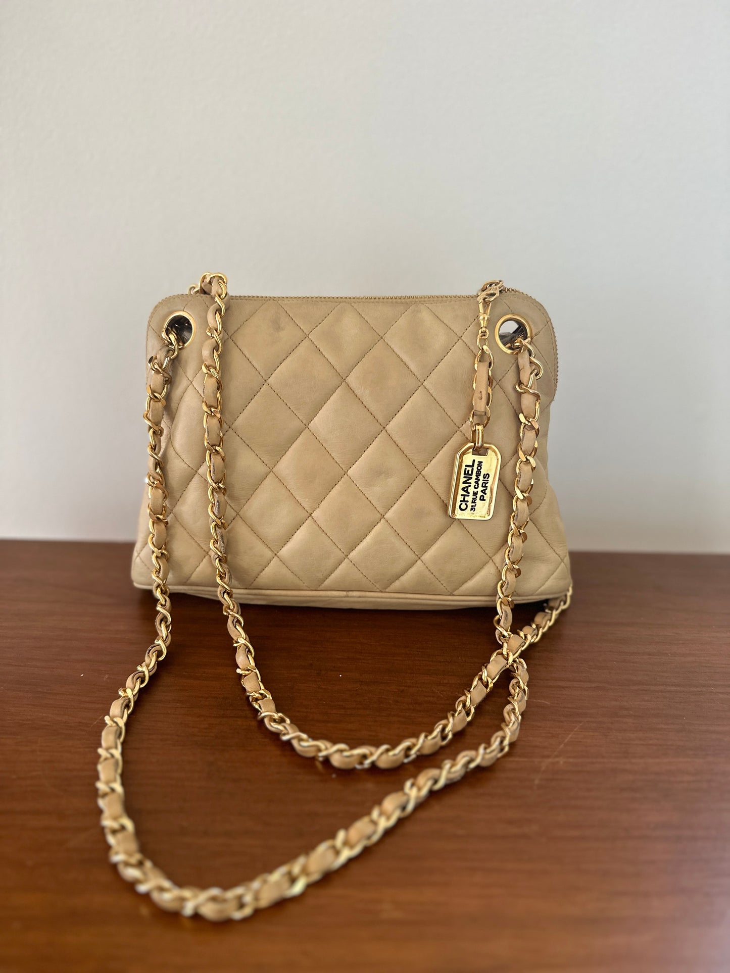 Chanel beige shoulder bag with gold hardware and tag